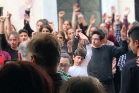 Image of youth in Greece showing solidarity by raising their fists