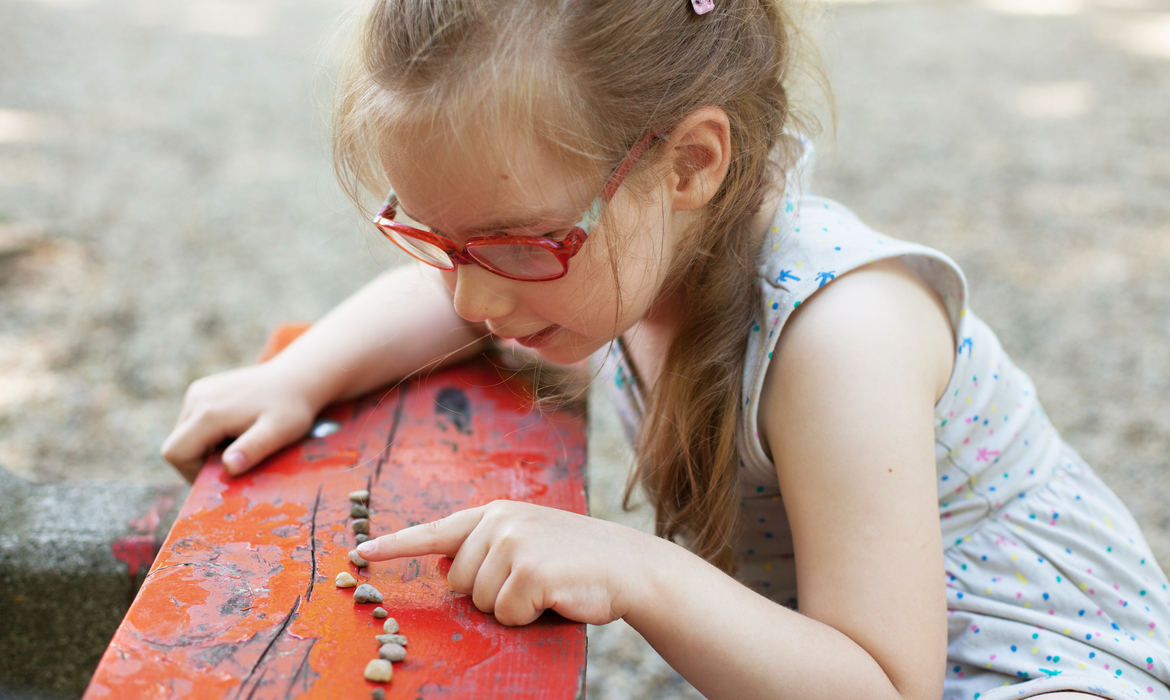 A student outside counting.