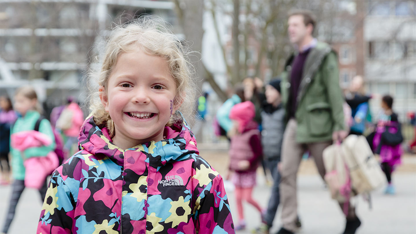 A child smiling and looking at the camera