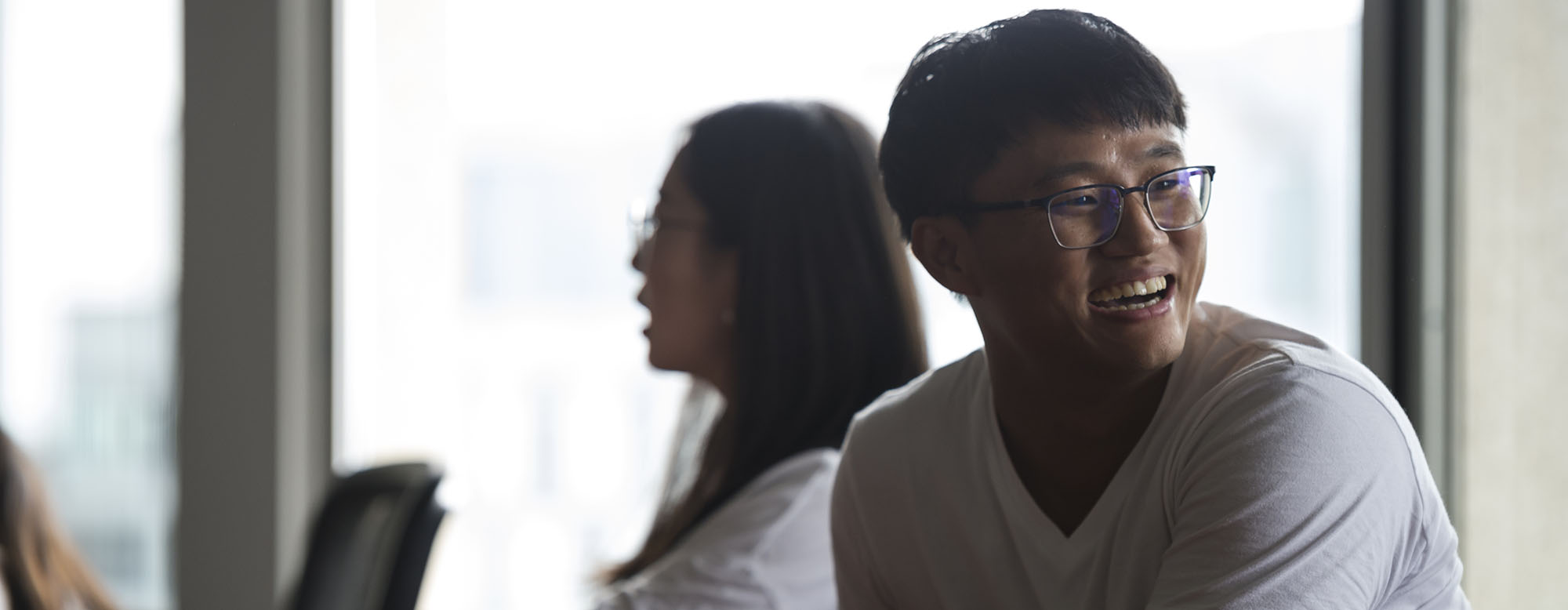 A student laughing and smiling at OISE Orientation