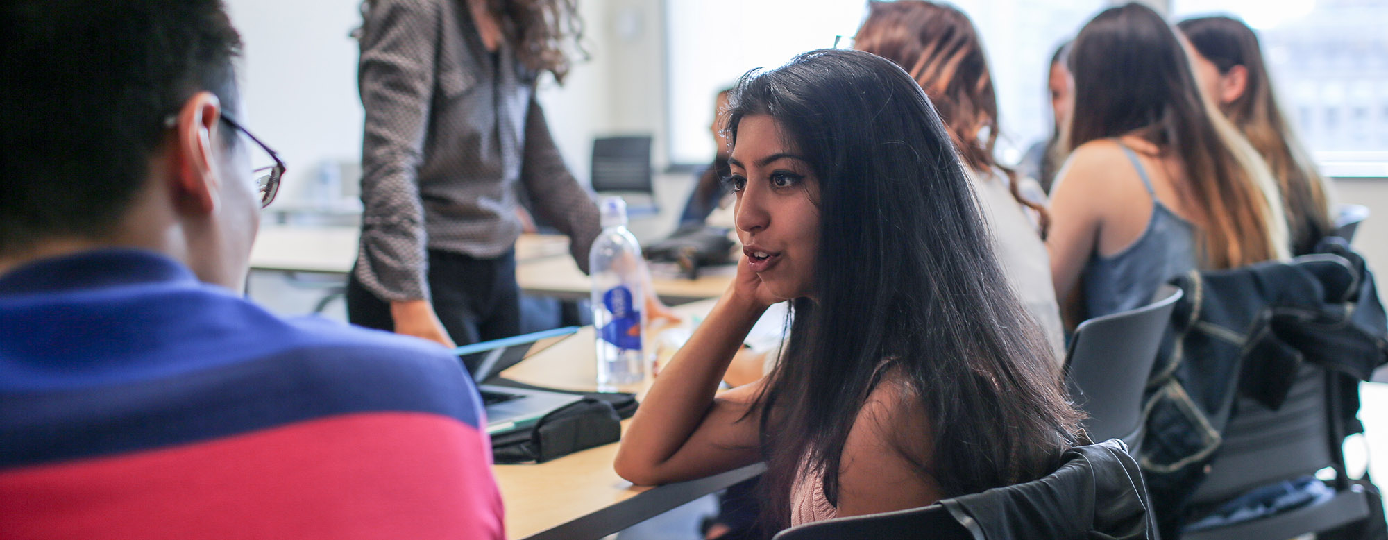 Students seated and talking in an OISE classroom.