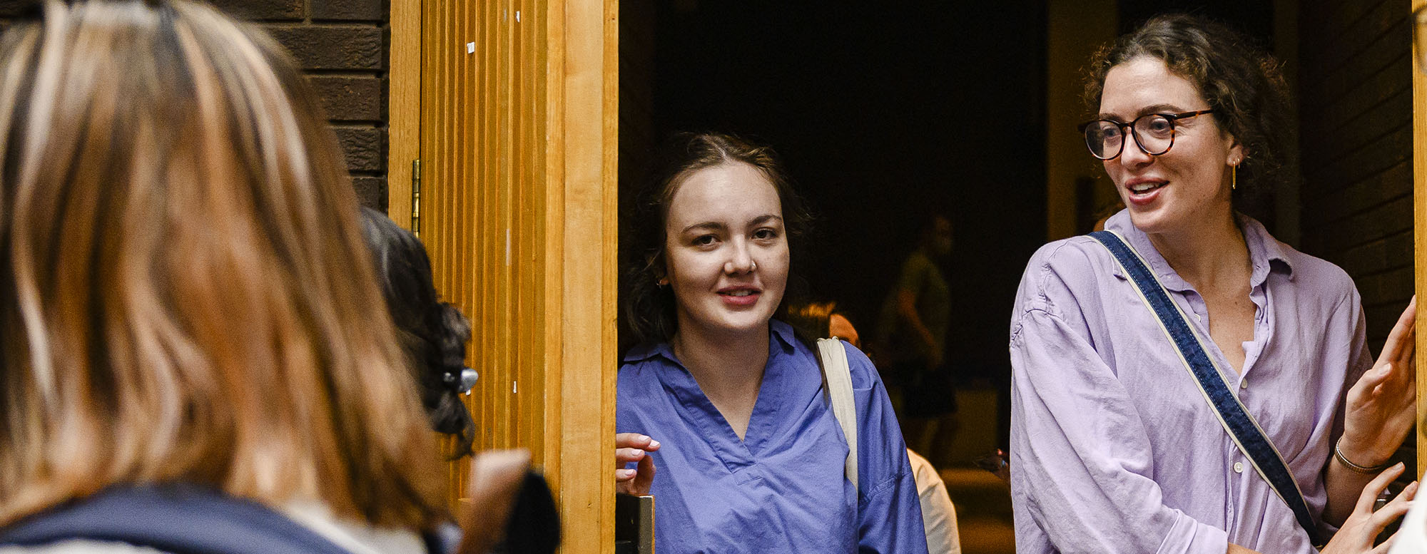 Two students standing in a doorway at OISE.