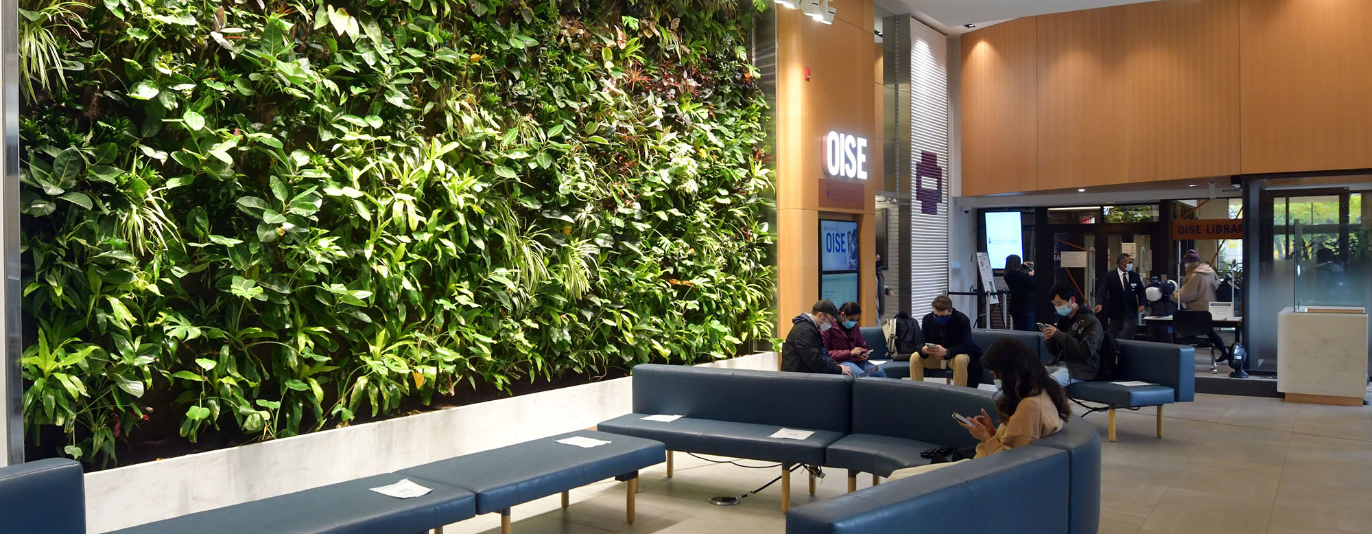 Students seated in the OISE lobby.