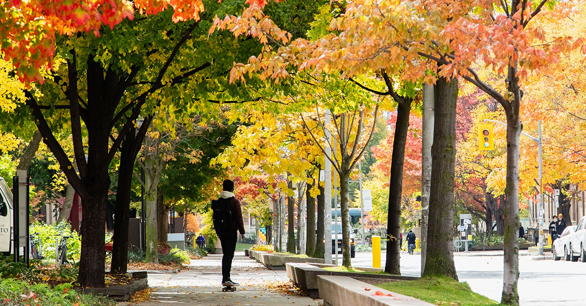 A person skateboarding through U of T's St. George Campus.