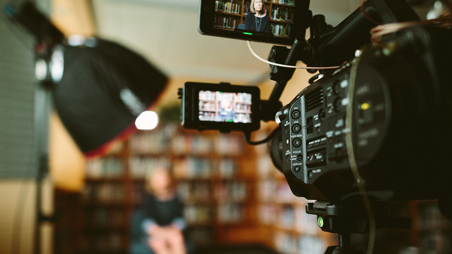 A person being recorded using a video camera.