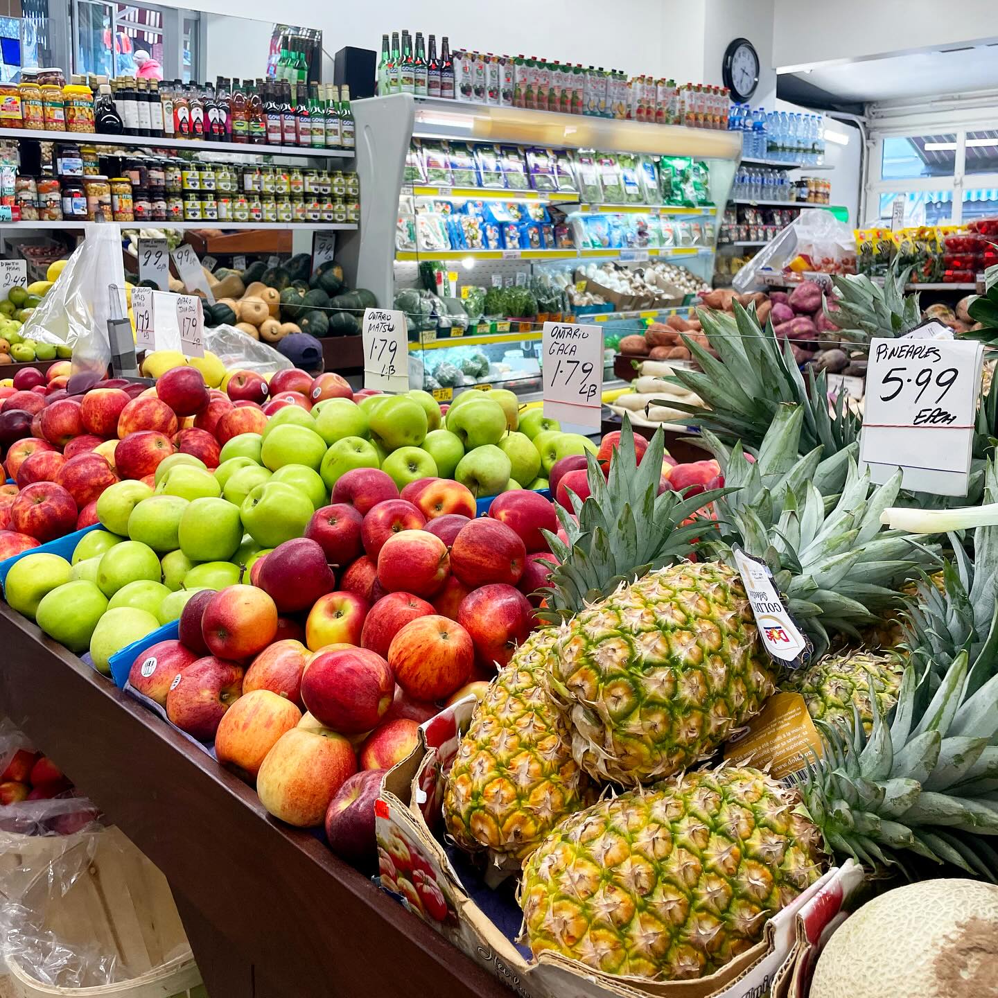 Fruits and vegetables arranged on tables and in bins