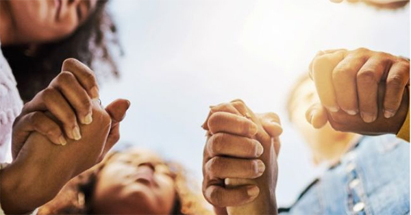 Three people holding hands.