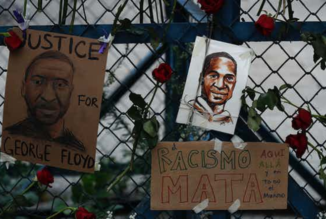 ‘Racism kills, here, there and in the whole world,’ reads a sign in Mexico City, at the U.S. Embassy in May 2020.