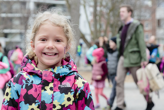 A child smiling and looking at the camera