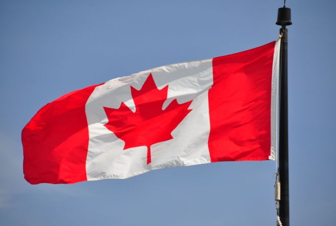 A Canadian flag blowing in the wind.