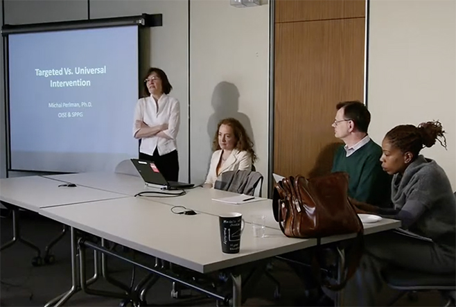 Four individuals presenting a presentation.