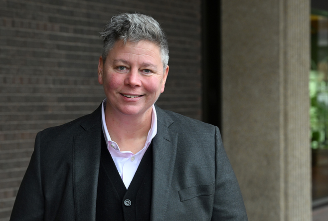 professor jen gilbert standing outside of the OISE building