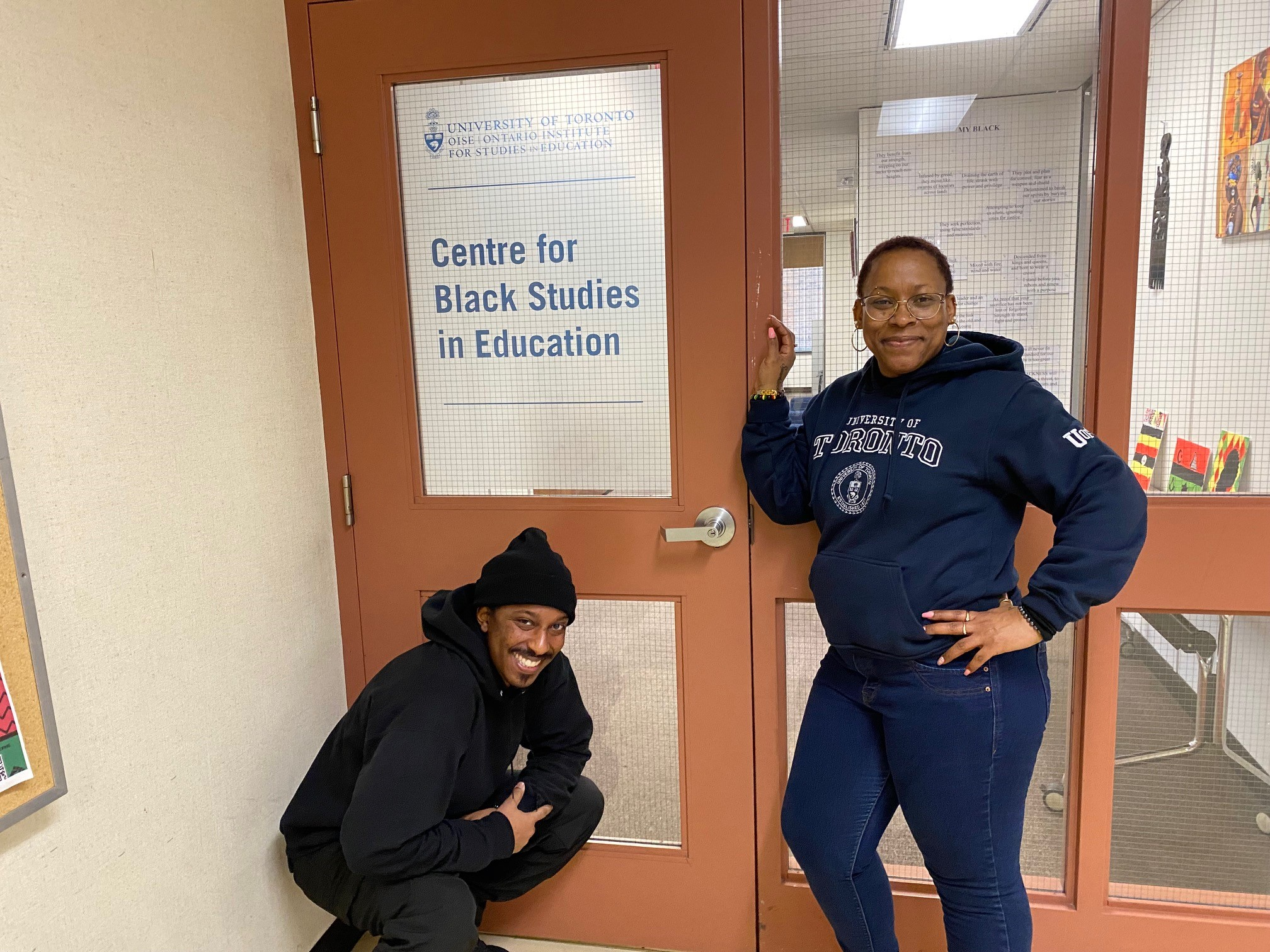 The Centre for Black Studies in Education Entrance With Two Black Students standing next to the Centre's Signage