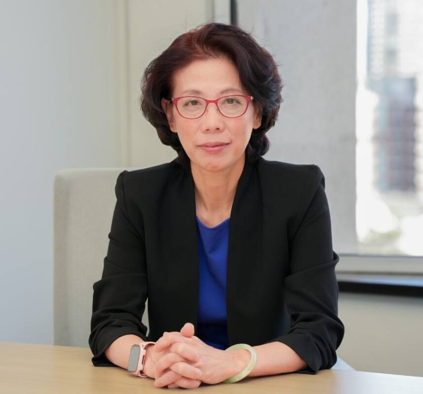 Portrait of Helen Huang, dark short hair in a blazer, wearing glasses