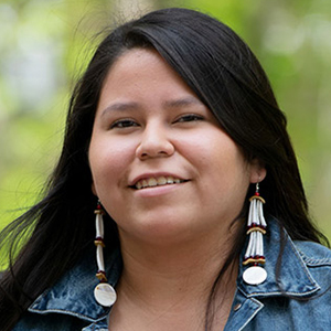 Diane Hill with long black hair and long earrings.