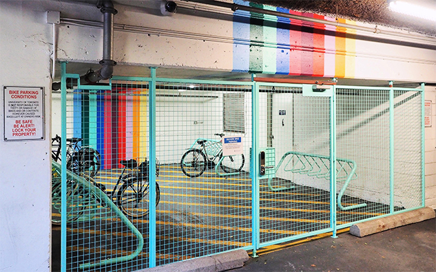 Photo of bike parking; bikes behind a secure, locked fence