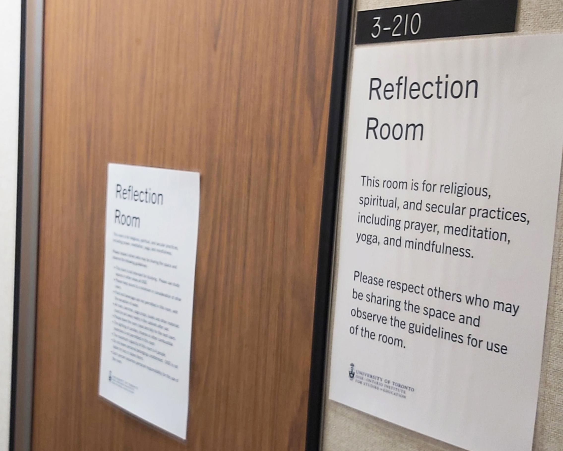 Photo of an office door with a sign posted beside it reading "Reflection Room"