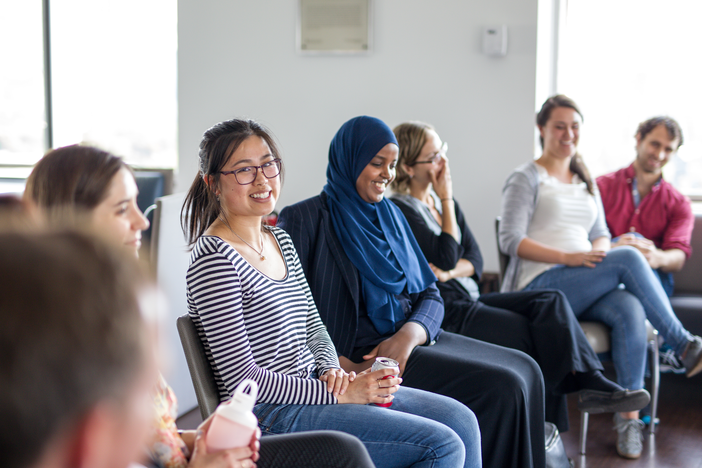 Group of 6 students sitting together in a row