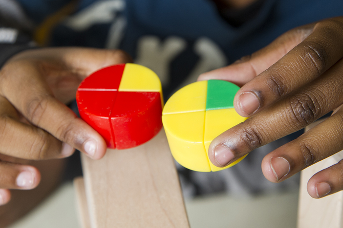 A child holding circular blocks.