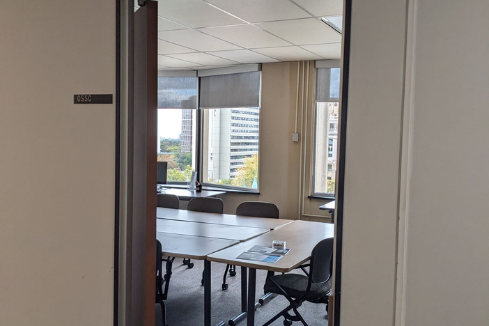 open door into windowed room with seminar style table 