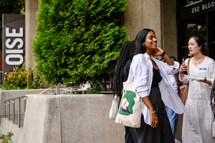 Students chatting with each other outside of the OISE building. 