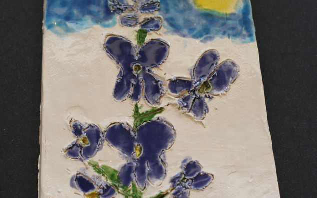 painting of a purple flower with blue sky, the round yellow sun on the right hand corner and green grass on the bottom