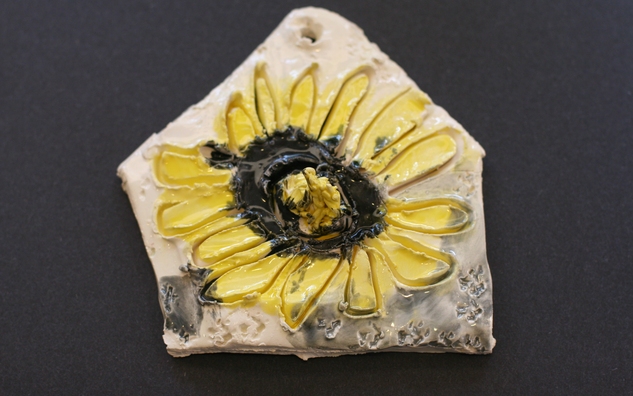 artwork detail of sunflower on clay