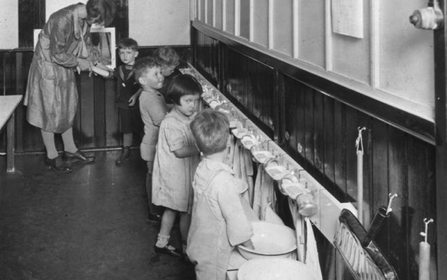 A dated photo of children washing their hands at JICS.