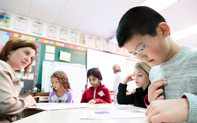 Students working on worksheets in a classroom.