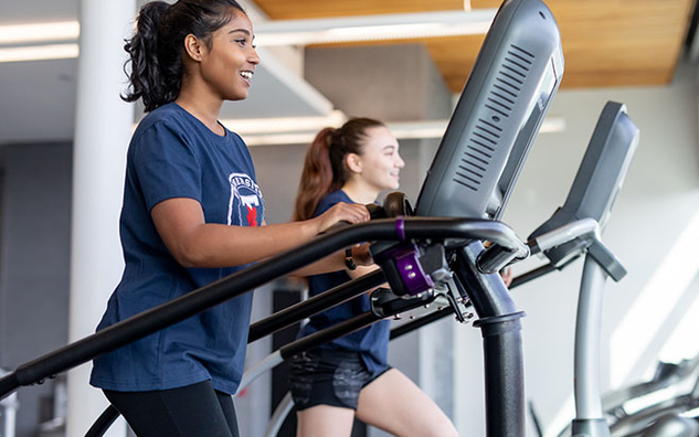 Two people using fitness equipment.