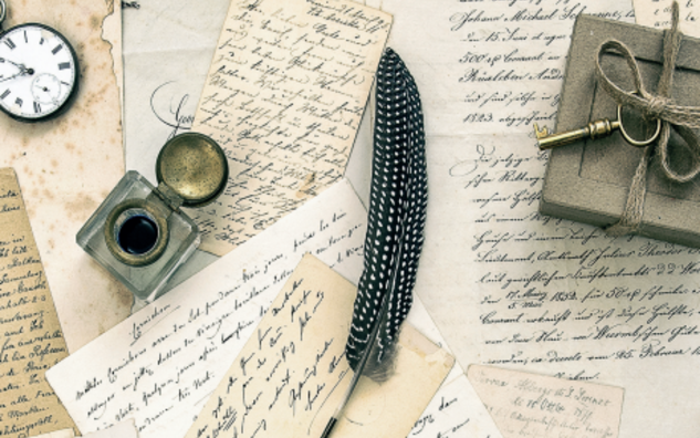 Handwritten letters and ink quill