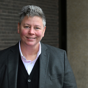 professor jen gilbert standing outside of the OISE building