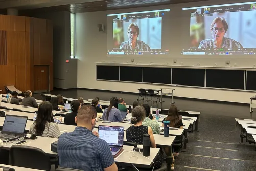 Individuals watching a presentation.