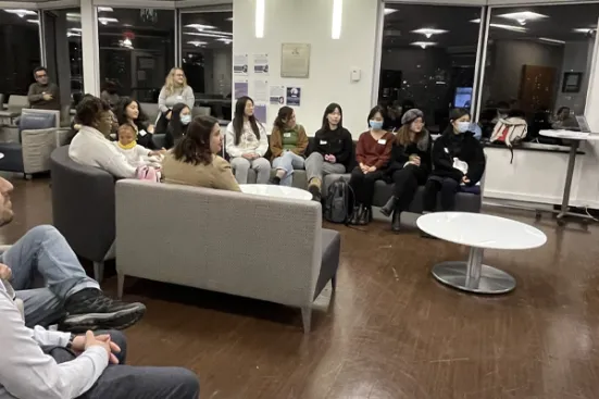 A group of attendees watching a presentation at the CERLL Welcome / Re-launch Party.