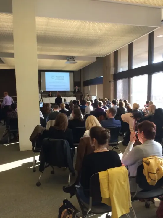 An audience watching a presentation in the OISE Library.