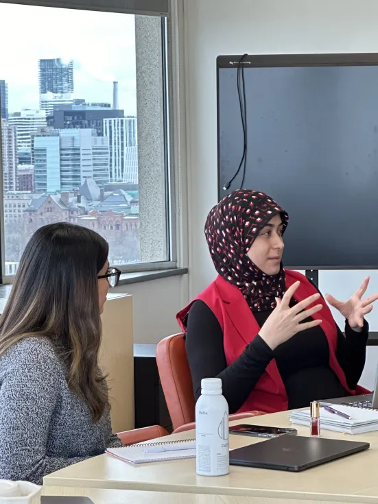 Two people sitting at a table having a discussion