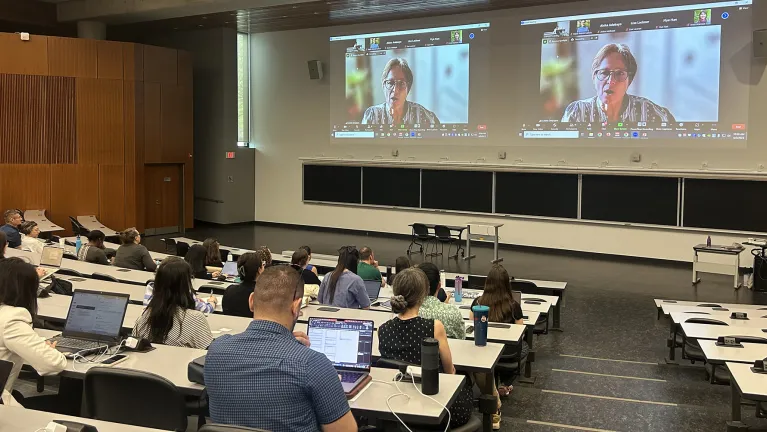 Individuals watching a presentation.